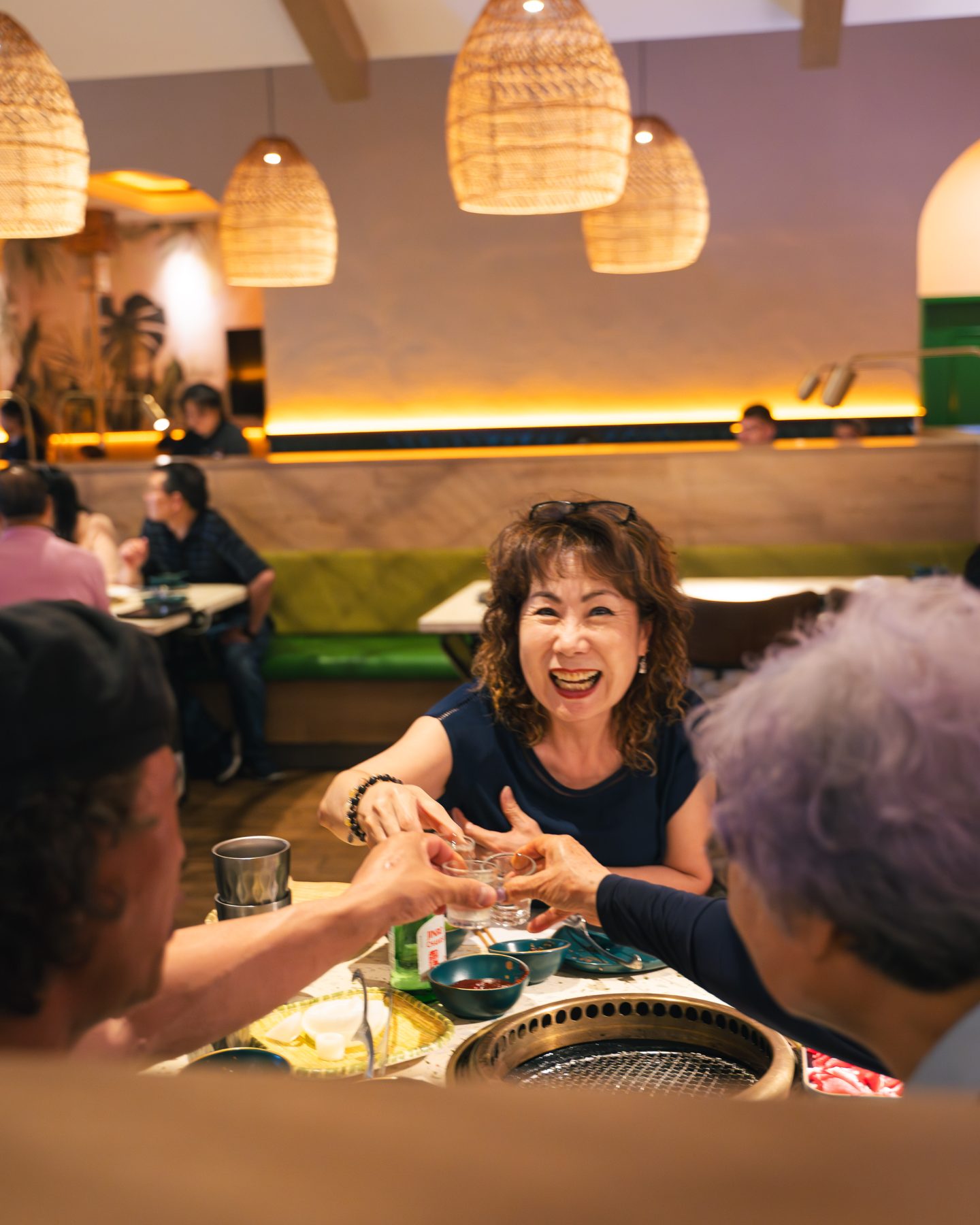 A family sharing a meal at a grill table at Kanpai BBQ & Hotpot