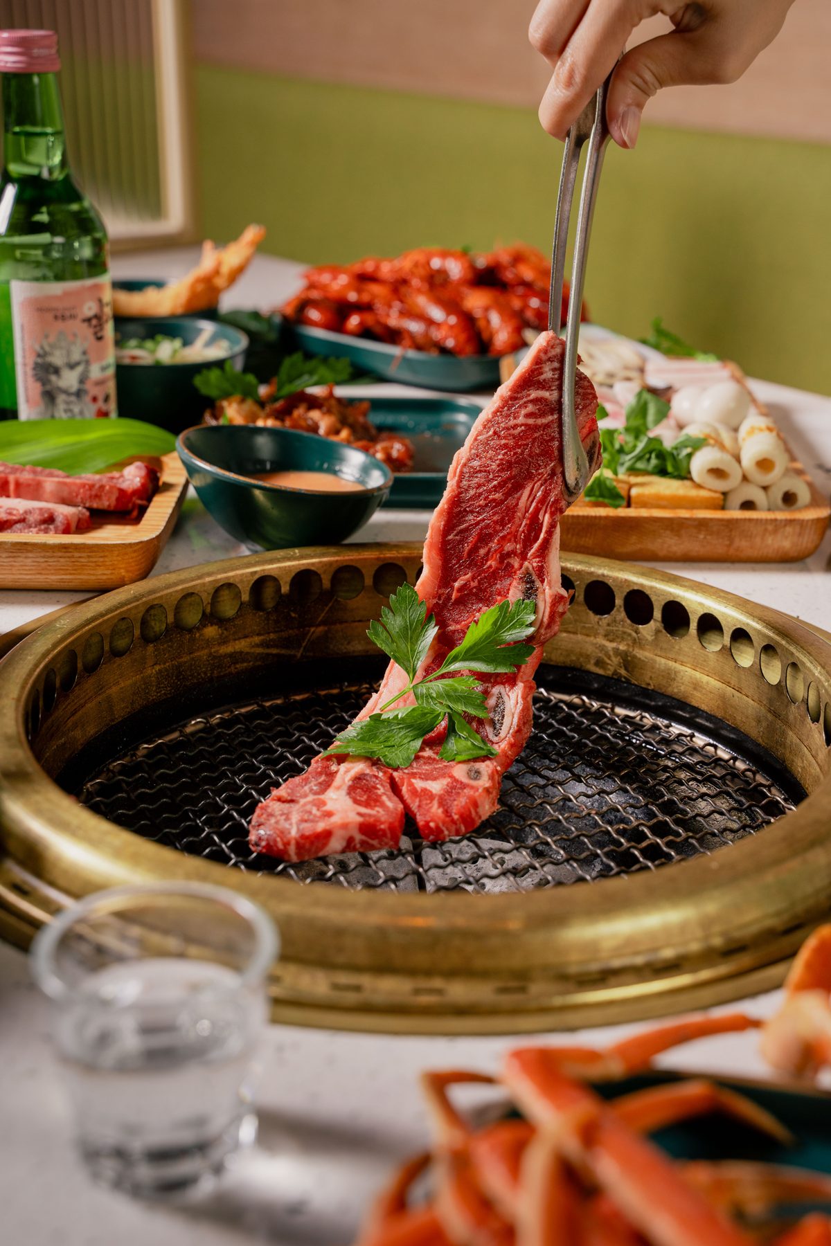 Marinated galbi lifted off the grill at Kanpai BBQ & Hotpot