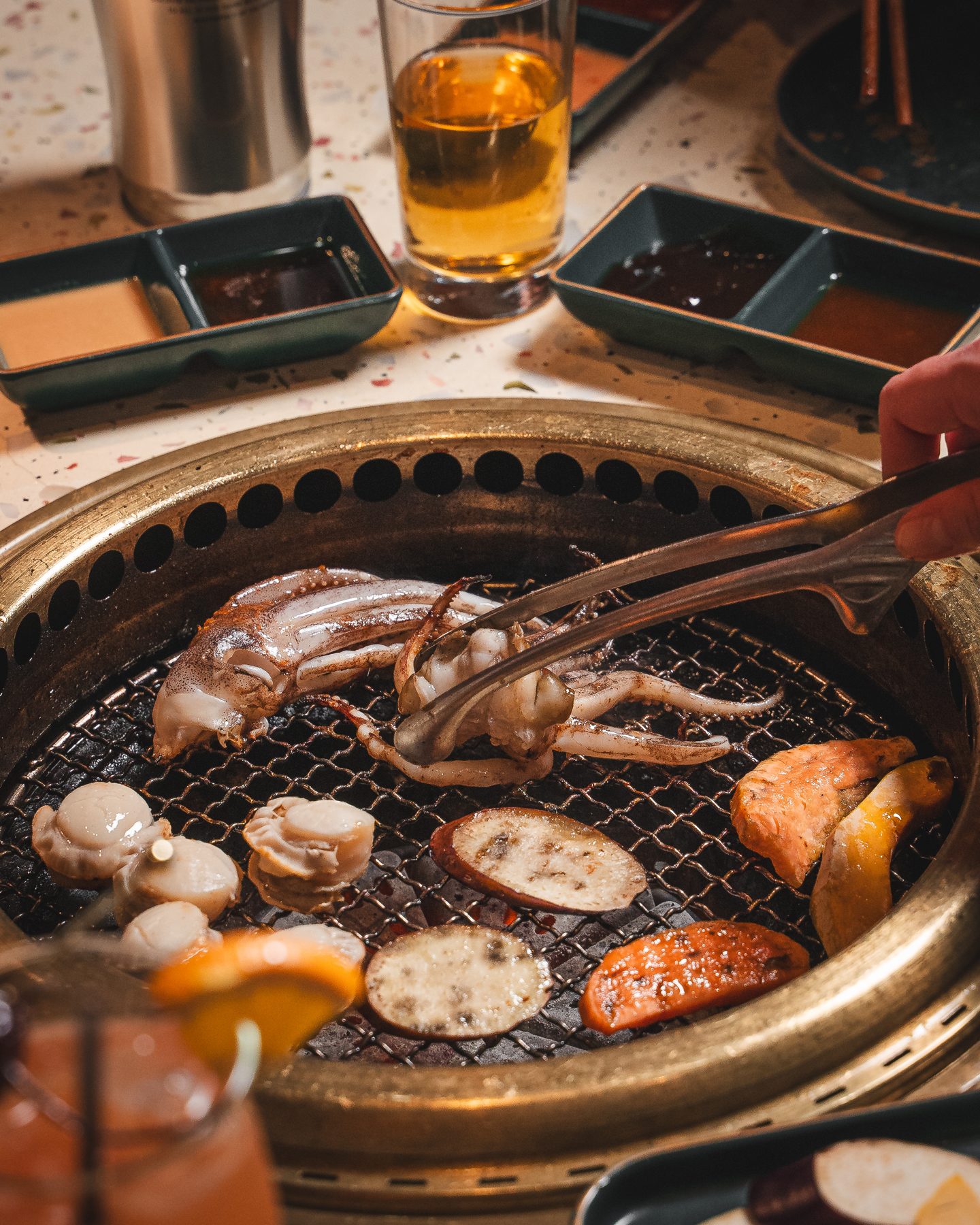 Squid and mushrooms on the table grill