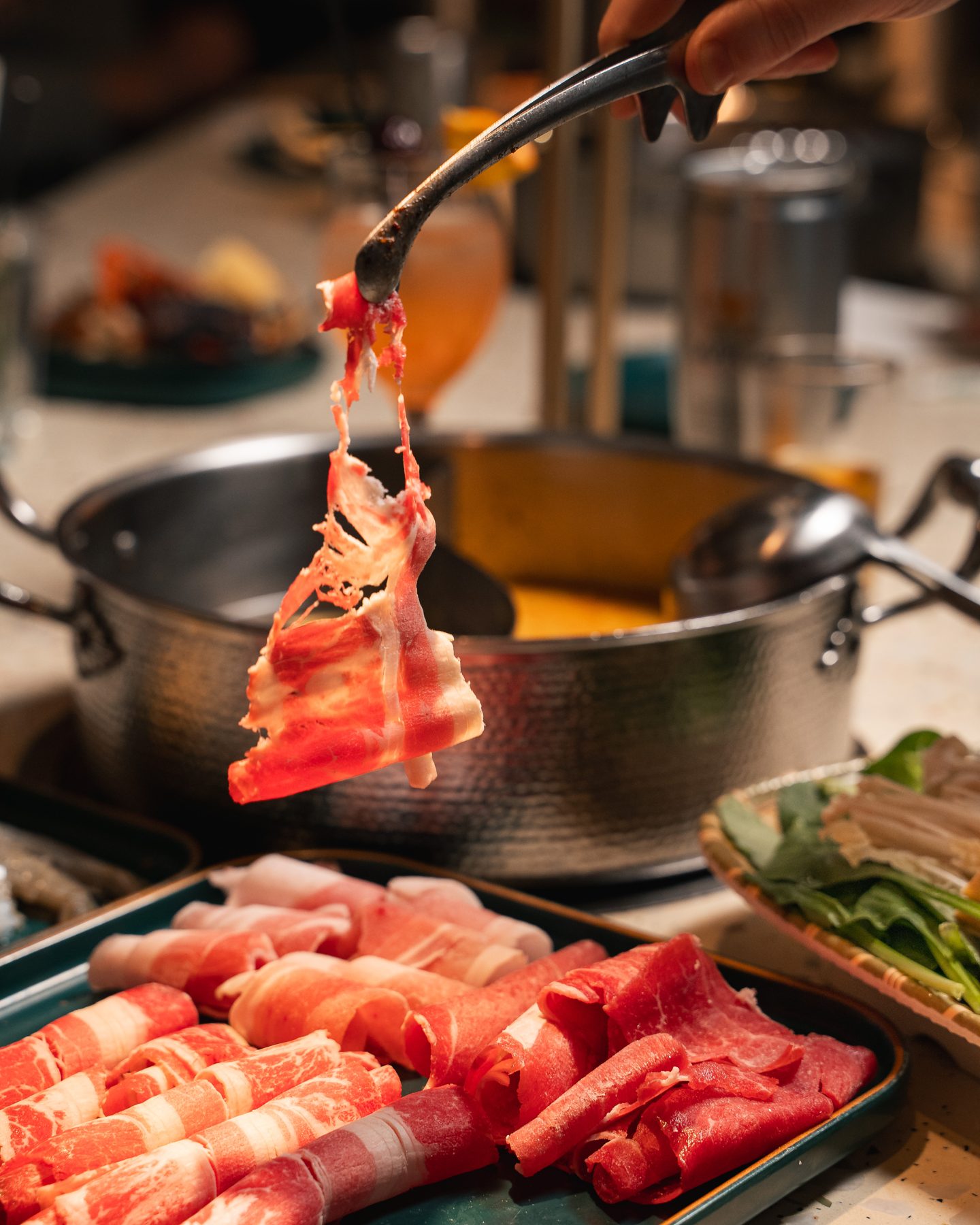 Thin-sliced meat dipped into the shabu shabu broth